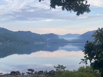 Scenic view of lake and mountains against sky