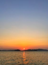 Scenic view of sea against orange sky