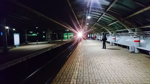 People in illuminated underground walkway