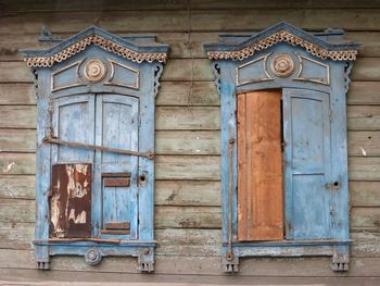 Closed window shutters on an old, weathered wooden house in irkutsk, russia