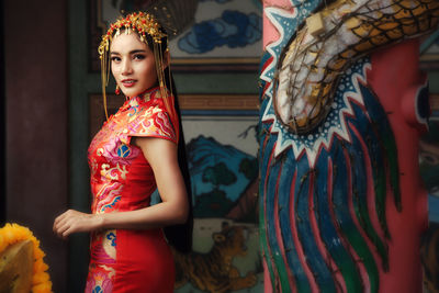 Beautiful asian woman in chinese dress traditional with congratulate gesture in chinese new year