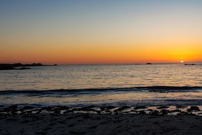 Scenic view of sea against clear sky during sunset