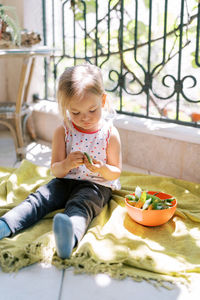 Portrait of cute boy sitting on table