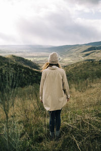 Rear view of man on landscape against sky