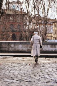 Full length rear view of woman walking in city