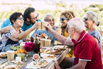 Group of people having food outdoors