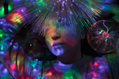 Close-up of woman with illuminated fiber optic in nightclub