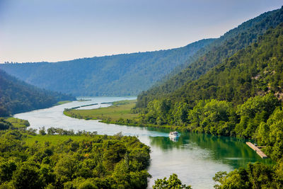 Scenic view of lake and trees against clear sky