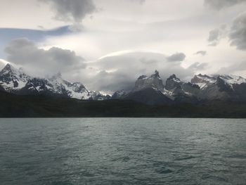 Scenic view of sea and mountains against sky