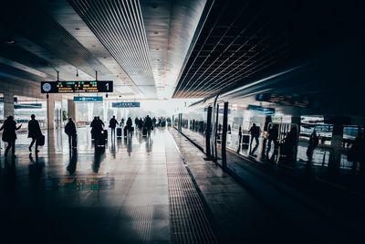 People waiting at railroad station platform