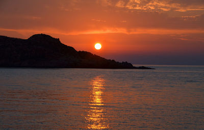 Scenic view of sea against romantic sky at sunset