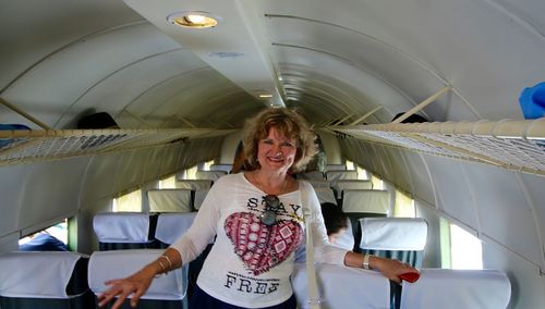 Portrait of woman standing in airplane