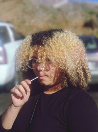 Portrait of a teenage boy holding leaf