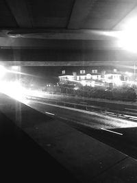 Illuminated railroad tracks in city at night