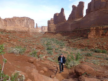 Rear view of man walking on rock