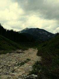 Scenic view of mountains against cloudy sky