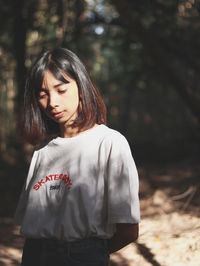 Close-up of a beautiful young woman in forest