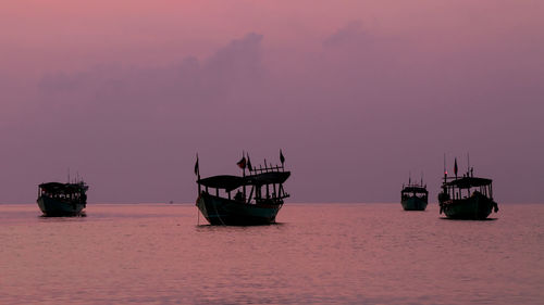 Koh rong island, cambodia at sunrise. strong vibrant colors, boats and ocean