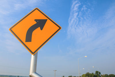 Low angle view of road sign against sky