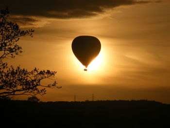 Silhouette landscape of hot air balloon against sky during sunset