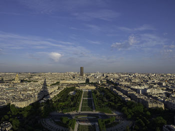 Aerial view of buildings in city against sky