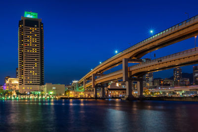 Low angle view of illuminated bridge against sky at night