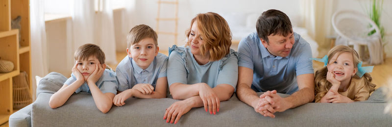 Big happy family sitting on sofa in living room, happy and joyful smile. family