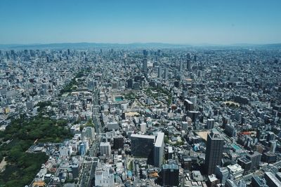 High angle view of modern buildings in city against clear sky