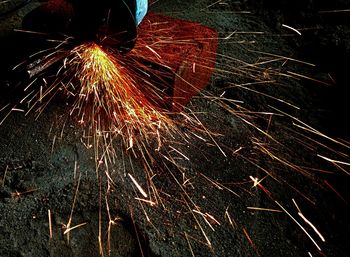 Low angle view of firework display at night
