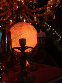 Close-up of illuminated electric lamp on table