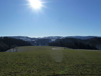 Scenic view of landscape against sky on sunny day