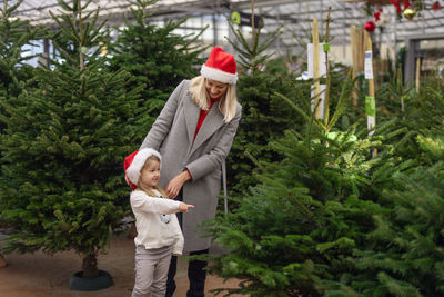 Mother and daughter buying christmas tree