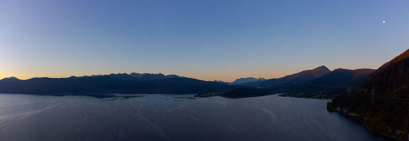 Scenic view of snowcapped mountains against clear sky during sunset