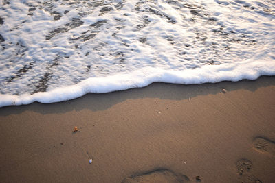 White wave of blue sea on sandy beach. natural background