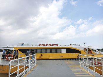 Yellow ship against sky