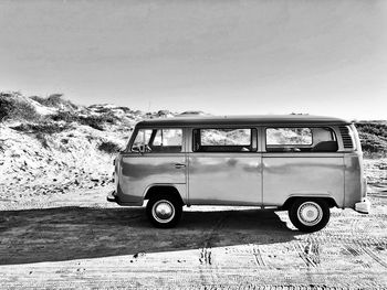 Vintage car on road against clear sky