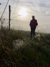 Rear view of man standing on field