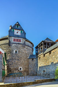 Low angle view of old building against clear blue sky