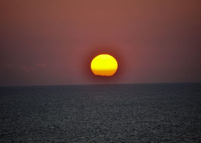 Scenic view of sea against romantic sky at sunset