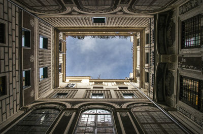 Low angle view of building against cloudy sky