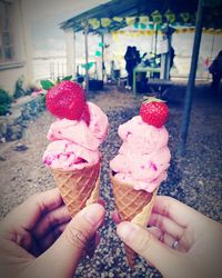 Cropped hand holding ice cream cone