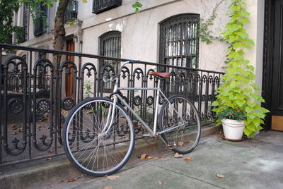 Bicycle against building in city