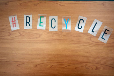 Close-up of text on wooden table