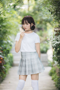 Full length of girl standing against plants