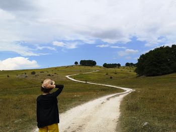 Hiker on mountain dirt road