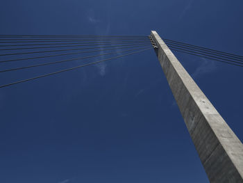Low angle view of bridge against clear blue sky