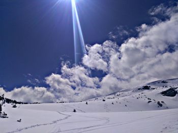 Scenic view of snowcapped mountains against sky on sunny day