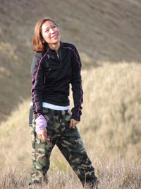 Portrait of smiling young woman standing outdoors