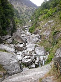 Scenic view of river amidst mountains against sky