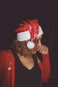 Woman wearing santa hat at night